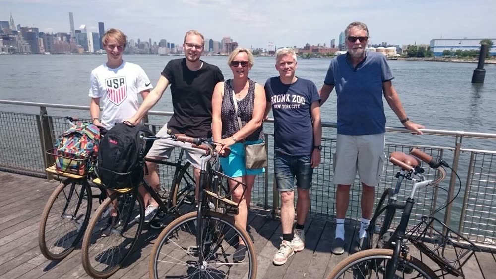A corporate group on a bike tour with the Manhattan skyline behind them